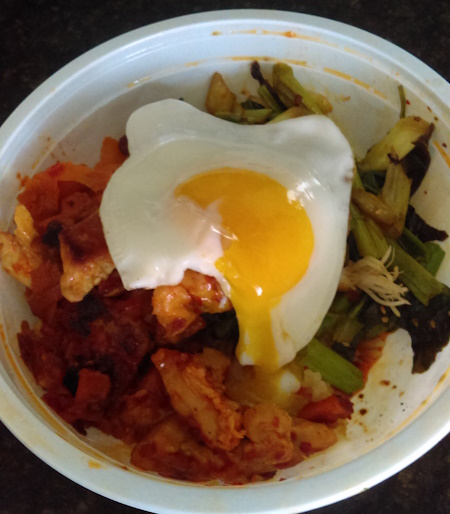 bibimbap in a white plastic bowl